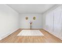 Inviting living room featuring hardwood floors, a plush rug, and neutral walls at 5562 Anaheim Way, Denver, CO 80239
