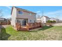 Grassy backyard featuring a wooden deck, perfect for outdoor entertaining and relaxation at 12134 Glencoe St, Thornton, CO 80241