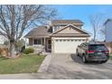 Charming two-story home with a well-maintained lawn and a spacious two car garage at 12134 Glencoe St, Thornton, CO 80241