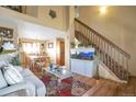Inviting living room featuring hardwood floors, a staircase, and an aquarium for a unique focal point at 12134 Glencoe St, Thornton, CO 80241