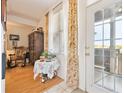Cozy entrance area featuring floral curtains, a charming table, and a glimpse of the outdoor view at 2846 W Centennial Dr # E, Littleton, CO 80123