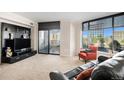 Bright living room with large windows, balcony access, and city views at 8100 E. Union Ave # 409, Denver, CO 80237