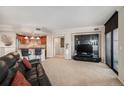 Open-concept living room with a kitchen island and integrated entertainment center at 8100 E. Union Ave # 409, Denver, CO 80237