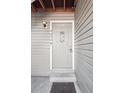 Inviting front door with decorative glass and house number, set in light grey siding at 4656 S Dillon Ct # D, Aurora, CO 80015
