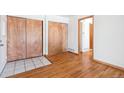 Open living space featuring hardwood flooring, a closet, and entrance to an adjacent room at 4656 S Dillon Ct # D, Aurora, CO 80015