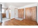 Inviting living area features hardwood floors, closet space, and an open view to the kitchen at 4656 S Dillon Ct # D, Aurora, CO 80015
