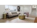 Bright living room features modern decor, light floors, neutral color palette, and a sun-filled view at 7114 S Costilla St, Littleton, CO 80120