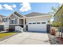 A well-maintained house showcasing a two-car garage, well-kept landscaping, and inviting curb appeal at 7202 S Valleyhead Ct, Aurora, CO 80016