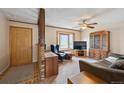 Cozy living room featuring a large window, ceiling fan and comfortable furnishings at 8731 W 89Th Pl, Broomfield, CO 80021