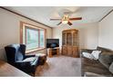 Inviting living room with large window for natural light, ceiling fan and plush sofa at 8731 W 89Th Pl, Broomfield, CO 80021