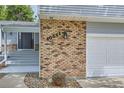 A close-up view of the front entrance of the home showing the address and attached garage at 10511 W 101St Ave, Broomfield, CO 80021