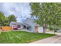 Charming two-story home with a manicured lawn, front porch swing, and established trees at 10511 W 101St Ave, Broomfield, CO 80021