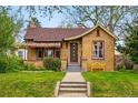 Inviting brick home with a landscaped front yard, enhancing curb appeal at 1312 Ash St, Denver, CO 80220