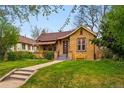 Quaint home featuring beautiful landscaping and inviting curb appeal at 1312 Ash St, Denver, CO 80220