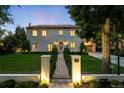 Elegant home exterior showcasing manicured lawn, gated entrance, and warm lighting, adding to its curb appeal at 181 Race St, Denver, CO 80206