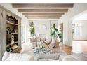 Bright living room showcasing exposed beam ceiling, hardwood floors, and neutral furniture for a cozy atmosphere at 181 Race St, Denver, CO 80206