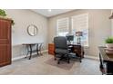 Bright home office with a large window, neutral carpet, and classic wooden furniture at 4077 Forever Cir, Castle Rock, CO 80109