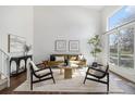 Inviting living room with large windows, modern furniture, and hardwood floors at 10275 Quail St, Westminster, CO 80021