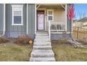 Front entrance with concrete steps leading to a covered porch at 2932 Low Meadow Blvd, Castle Rock, CO 80109