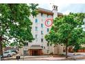 Multi-story building with lush trees, street view, and a red circled window at 1125 N Washington St # 501, Denver, CO 80203