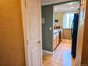 Hallway view leading to a kitchen with modern appliances and fixtures at 1125 N Washington St # 501, Denver, CO 80203