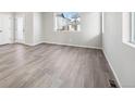 Bright and spacious living room with beautiful wood floors, offering a clean and modern aesthetic at 21142 E 63Rd Dr, Aurora, CO 80019