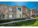 Charming condo with well-kept lawn, private entry, and exterior staircase at 8775 W Berry Ave # 101, Littleton, CO 80123