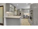 Well-equipped kitchen with stainless appliances, granite countertops, modern cabinetry and a decorative backsplash at 12020 W Alabama Pl, Lakewood, CO 80228