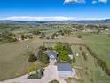 Aerial view showcases the home's location with mountain views in the background at 2610 W County Road 4, Berthoud, CO 80513