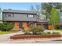 Attractive two-story home with a brick facade, gray siding, well-maintained landscaping, and a two-car garage at 2448 S Leyden St, Denver, CO 80222