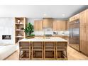 Modern kitchen features a center island with seating, stainless steel appliances, and ample counter space at 265 S Monroe St, Denver, CO 80209