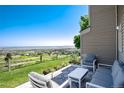 Enjoy stunning views from the back patio, complete with stylish outdoor seating and a lush lawn at 6980 Fargo Trl, Littleton, CO 80125