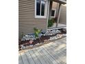 Exterior of the home with stylish deck, rock detail, meticulous landscaping, and fresh mulch for a neat appearance at 6980 Fargo Trl, Littleton, CO 80125