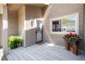 Charming front porch adorned with lush greenery and a 'For Sale' sign, welcoming potential buyers at 6980 Fargo Trl, Littleton, CO 80125