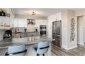 Modern kitchen with gray and white cabinets and granite countertop at 6980 Fargo Trl, Littleton, CO 80125