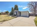 Attractive single-story home featuring a spacious driveway and a charming front yard at 7240 S Cherry Dr, Centennial, CO 80122