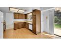 Functional kitchen with wood cabinets, laminate countertops, and a window over the sink at 8204 S Cody St, Littleton, CO 80128