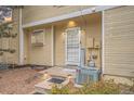 Inviting townhome entrance featuring a decorative door, enhanced lighting, and neat landscaping for a charming welcome at 4038 S Richfield Way, Aurora, CO 80013