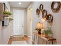 Inviting entryway with wood floors, accent wall decor and view of the living space at 18067 E Anthem Dr, Parker, CO 80134