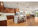 Open concept kitchen with granite countertops, center island, and hardwood floors at 18067 E Anthem Dr, Parker, CO 80134