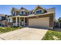 Spacious two car garage with brick and siding exterior, and a large driveway at 16534 E Fire Fly Ave, Parker, CO 80134