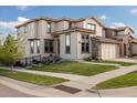 Charming two-story home featuring a well manicured lawn and a two car garage at 15218 W La Salle Ave, Lakewood, CO 80228