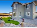 Landscaped backyard with a putting green and rock features at 4616 Girardot Pt, Castle Rock, CO 80104