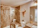 Modern bathroom with a walk-in shower, tile surround, and contemporary fixtures at 4616 Girardot Pt, Castle Rock, CO 80104