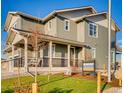 Two-story house with gray siding, a front porch, and a landscaped lawn at 4616 Girardot Pt, Castle Rock, CO 80104