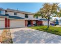 Two-story brick townhouse with attached garage and front yard at 4618 S Newton St, Denver, CO 80236