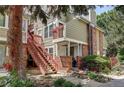 Charming exterior of a multi-level home with brick accents and access stairs at 919 S Dawson Way # 14, Aurora, CO 80012