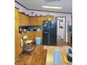 Traditional kitchen with wood cabinets, black refrigerator, and light-colored countertops at 313 W 3Rd Ave, Byers, CO 80103