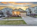 Inviting single-Gathering home featuring a charming front porch and well-maintained landscaping at 18922 W 84Th Ave, Arvada, CO 80007