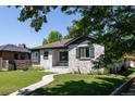 Beautiful white brick exterior with manicured lawn and winding sidewalk to the covered entry of this home at 2995 N Cherry St, Denver, CO 80207